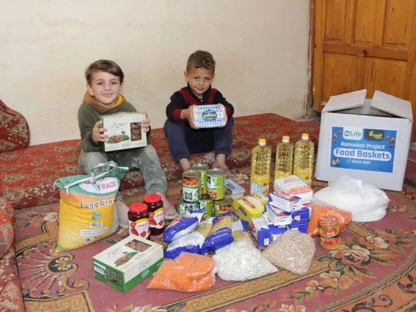 Volunteers packing baskets with essentials